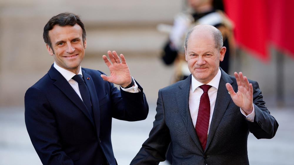 French President Emmanuel Macron welcomes German Chancellor Olaf Scholz as he arrives to attend an informal summit of EU leaders at the Chateau de Versailles (Versailles Palace), amid Russia's invasion of Ukraine, in Versailles, near Paris, France, March 10, 2022.